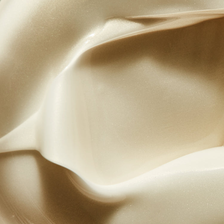 Close-up texture of a thick, shimmering, off-white cream