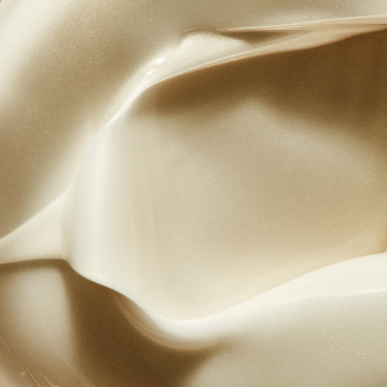 Close-up texture of a thick, shimmering, off-white cream