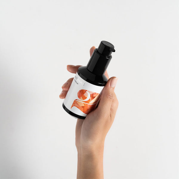 Hand holds a black pump bottle labeled RATIONALE