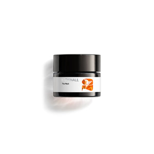 Small dark glass jar labeled RATIONALE The Mask