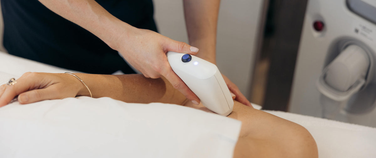 Aesthetic clinic skin treatments in Sydney, with a therapist using a handheld device on a client arm